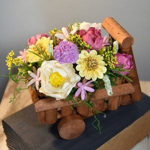 Cheerful garden arrangement of airbrushed Sola wood flowers in a garden cart